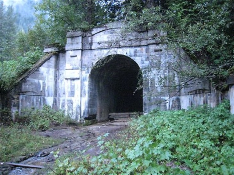 The western portal of the long-abandoned Great Northern Railway tunnel beneath Stevens Pass, Wash., is shown. The tunnel ends at what was once the railroad town of Wellington, Wash., where the nation's worst avalanche disaster occurred 100 years ago, when two passenger trains were swept away by a snow slide, killing nearly 100 people.